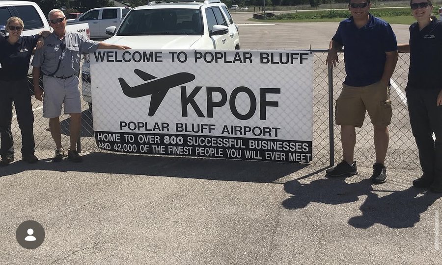 Welcome to Poplar Bluff Airport sign with the crew