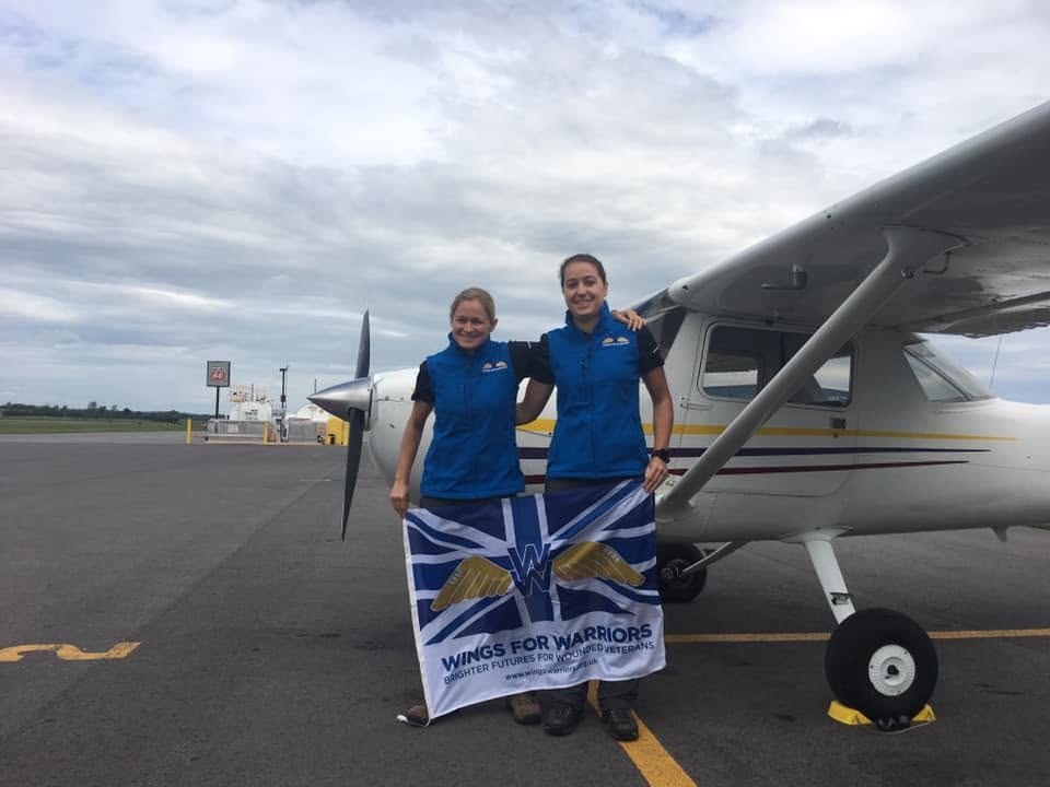 Tess and Morag Morris-Paterson with the Wings for Warriors flag beside the Cessna 150 at the start of the This Girl Flies attempt